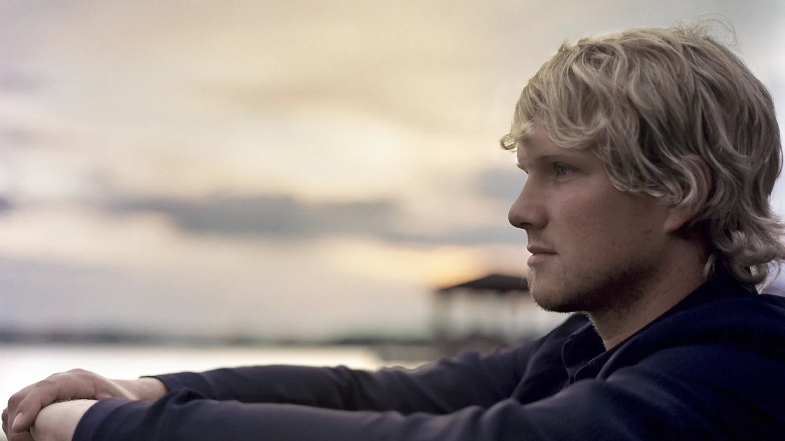David Martin looking out over the water at dusk